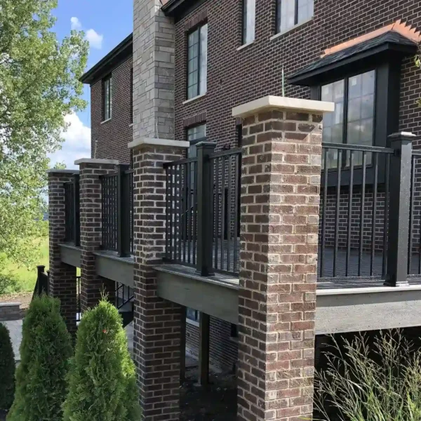 elevated outdoor deck with brick columns and black railing
