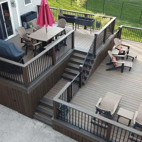 aerial view of a multi-level composite pool deck with outdoor furniture