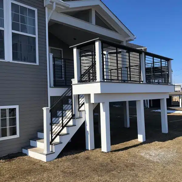 photo of a covered deck with deck railing and steps