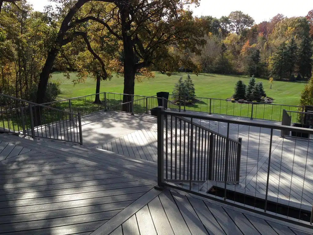 6 Above-Ground Pool Deck Ideas gray deck with metal railing 6