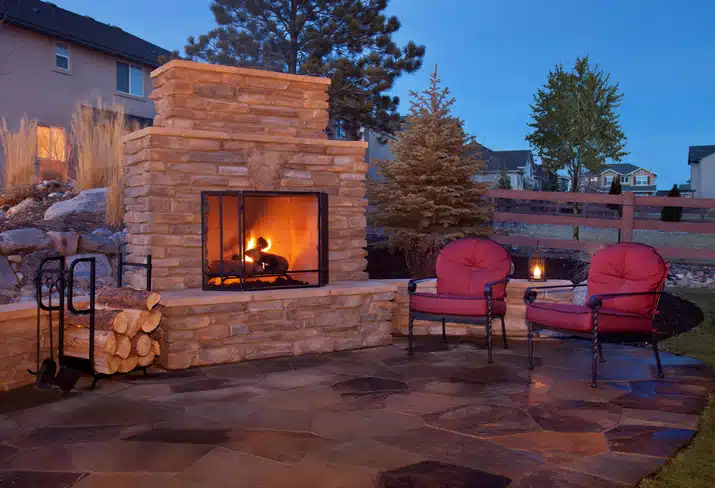 outdoor flagstone platform with fireplace, chairs