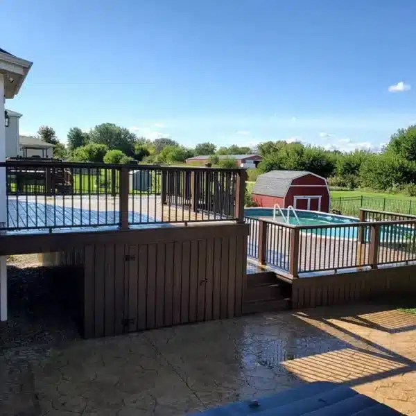side view of a photo of a multi-level composite pool deck that includes underdeck storage