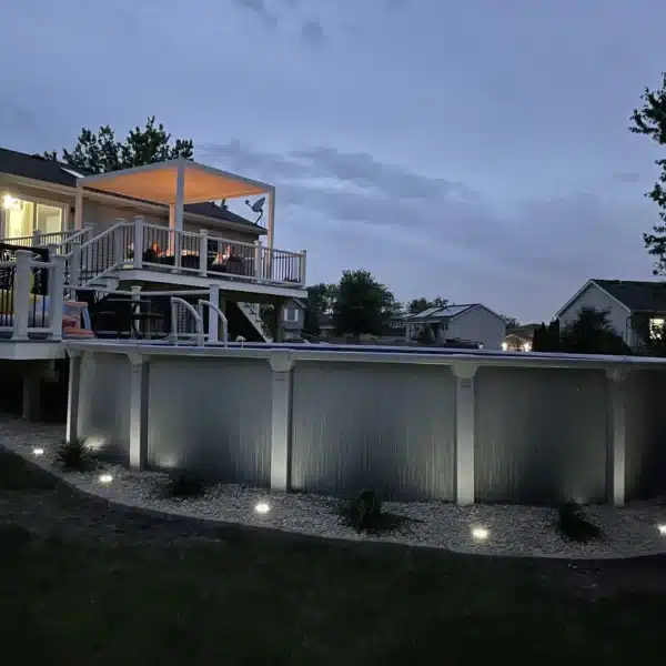 photo of multi-level pool deck with outdoor lighting and renovated landscape