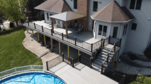 photo of an elevated deck with a lower-level pool deck - Build a deck in winter