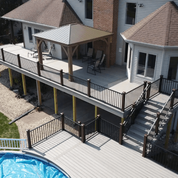 photo of an elevated deck with a lower-level pool deck - build a deck in winter