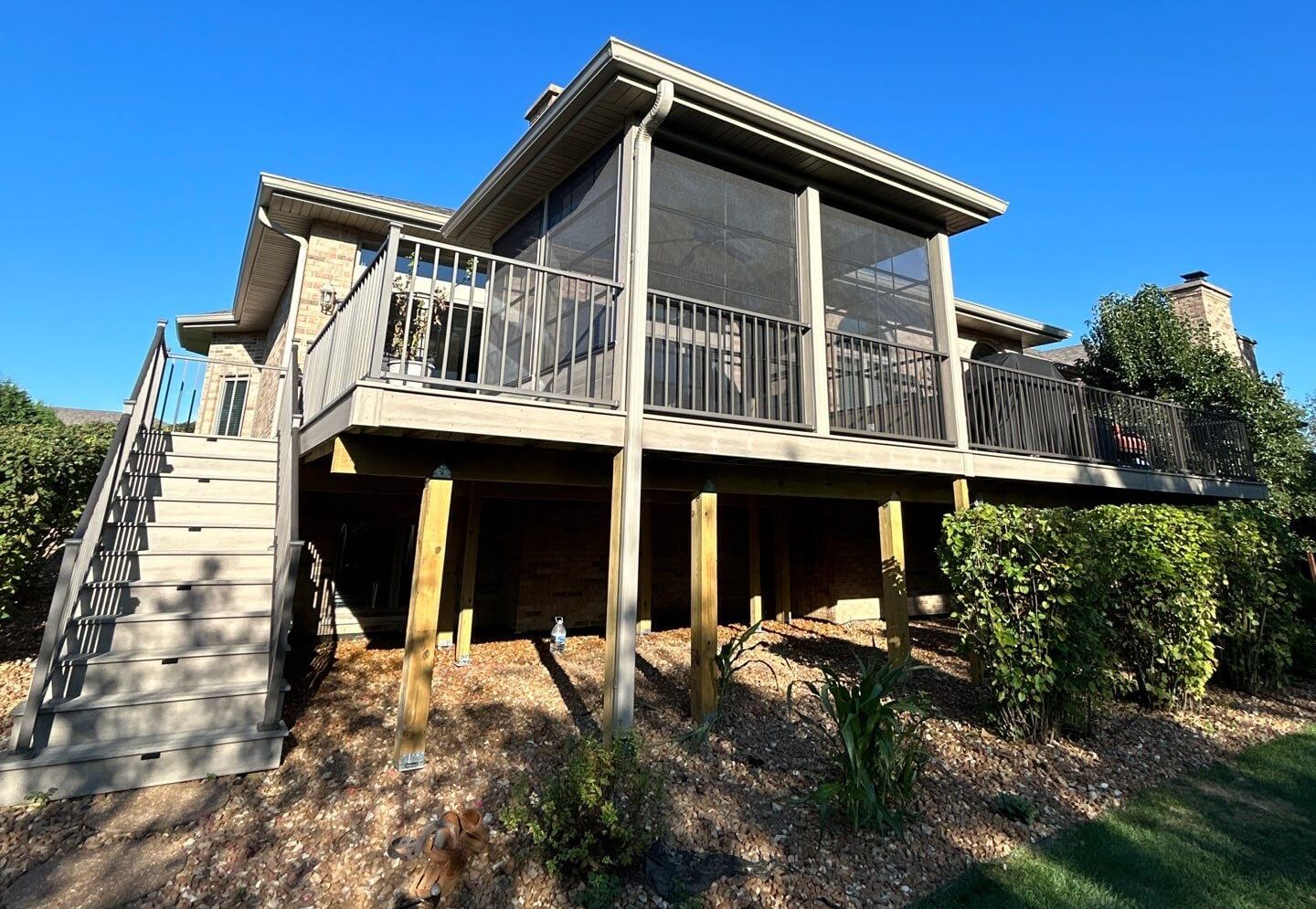 photo of elevated deck with a solid roof covering on screen room